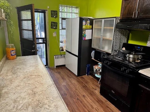 a kitchen with stainless steel appliances granite countertop a refrigerator and a stove top oven