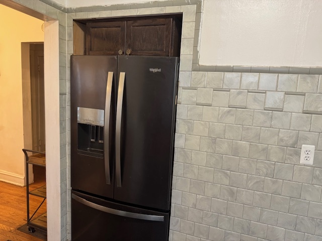 5829 North Washtenaw Avenue Chicago, IL 60659 - Photo 13 of 39 a view of a refrigerator in kitchen and an empty room in wooden floor