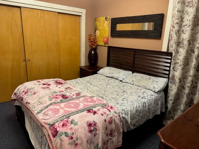 a bedroom with bed and a window