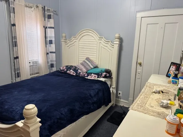 a bedroom with a bed and a fireplace