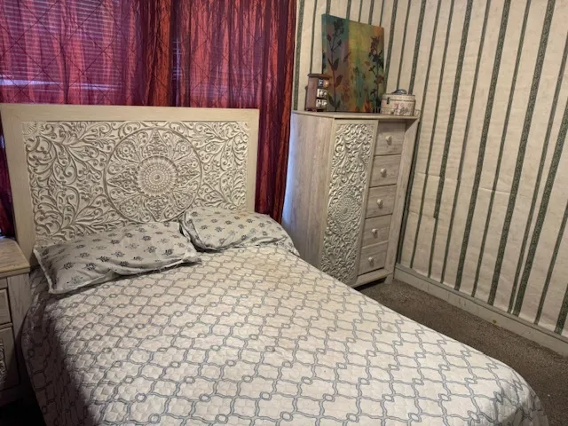 a bedroom with a bed and a table