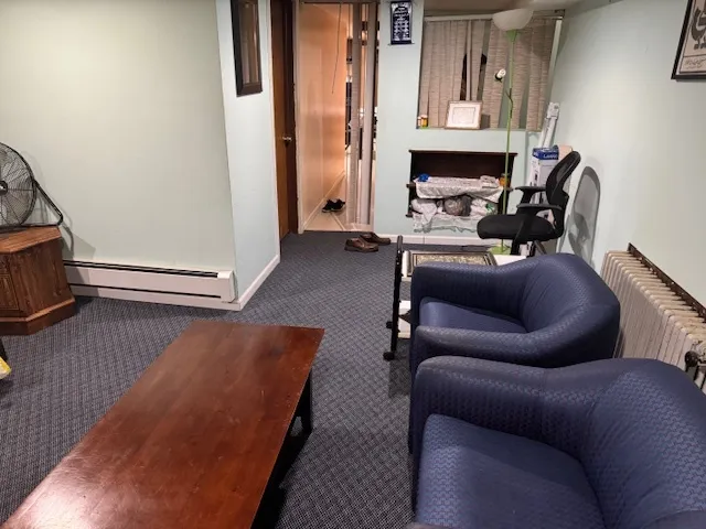 a view of a hallway with wooden floor and stairs