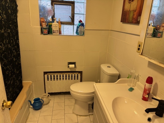 5829 North Washtenaw Avenue Chicago, IL 60659 - Photo 32 of 39 a bathroom with a sink and a mirror