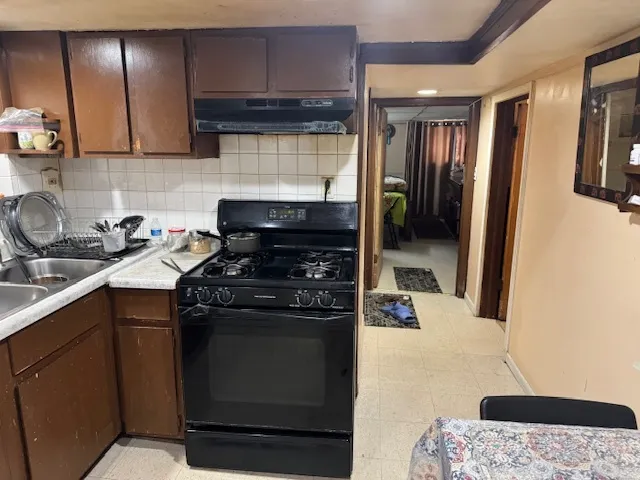 a kitchen with a stove and a refrigerator