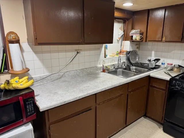 a kitchen with stainless steel appliances granite countertop a sink stove and cabinets