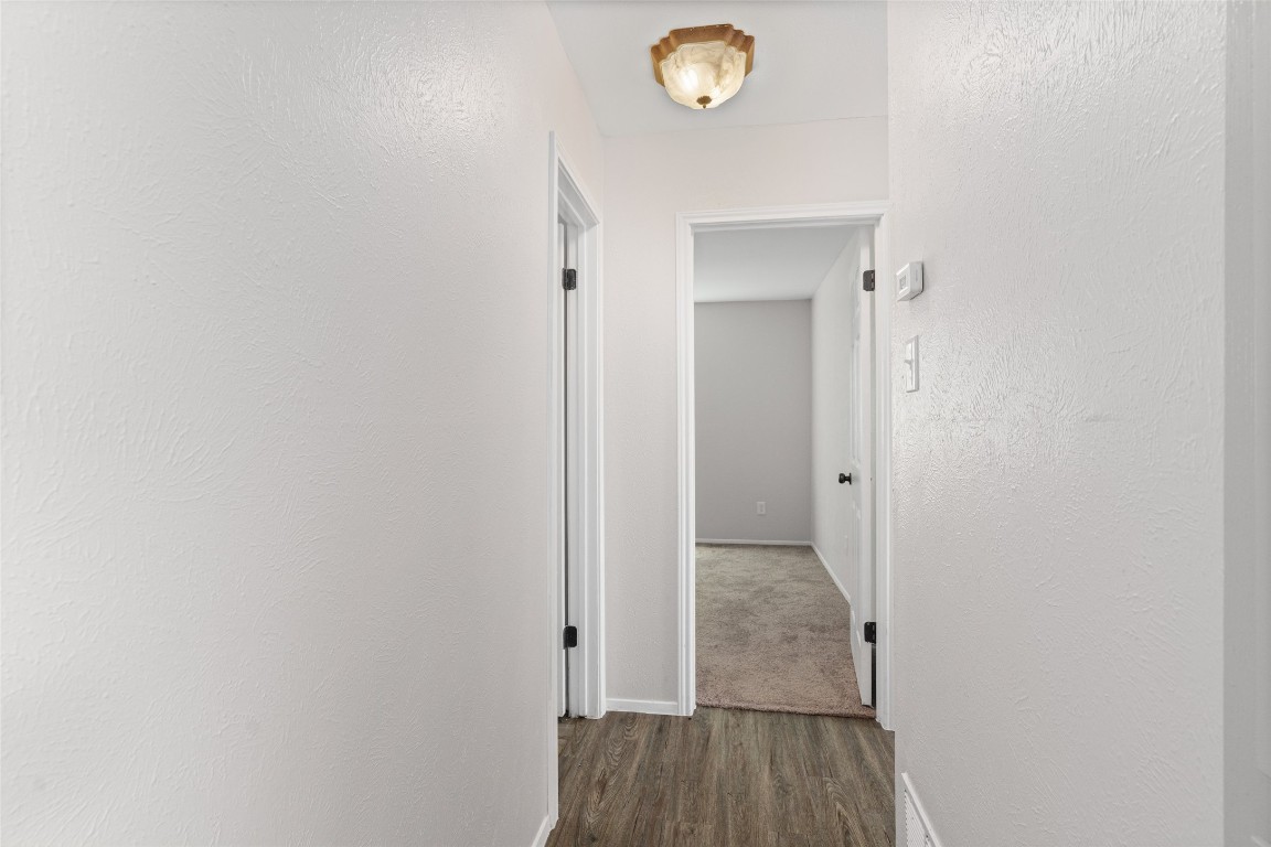 8615 Croydon Loop Austin, TX 78748 - Photo 12 of 28 a view of a hallway with wooden floor