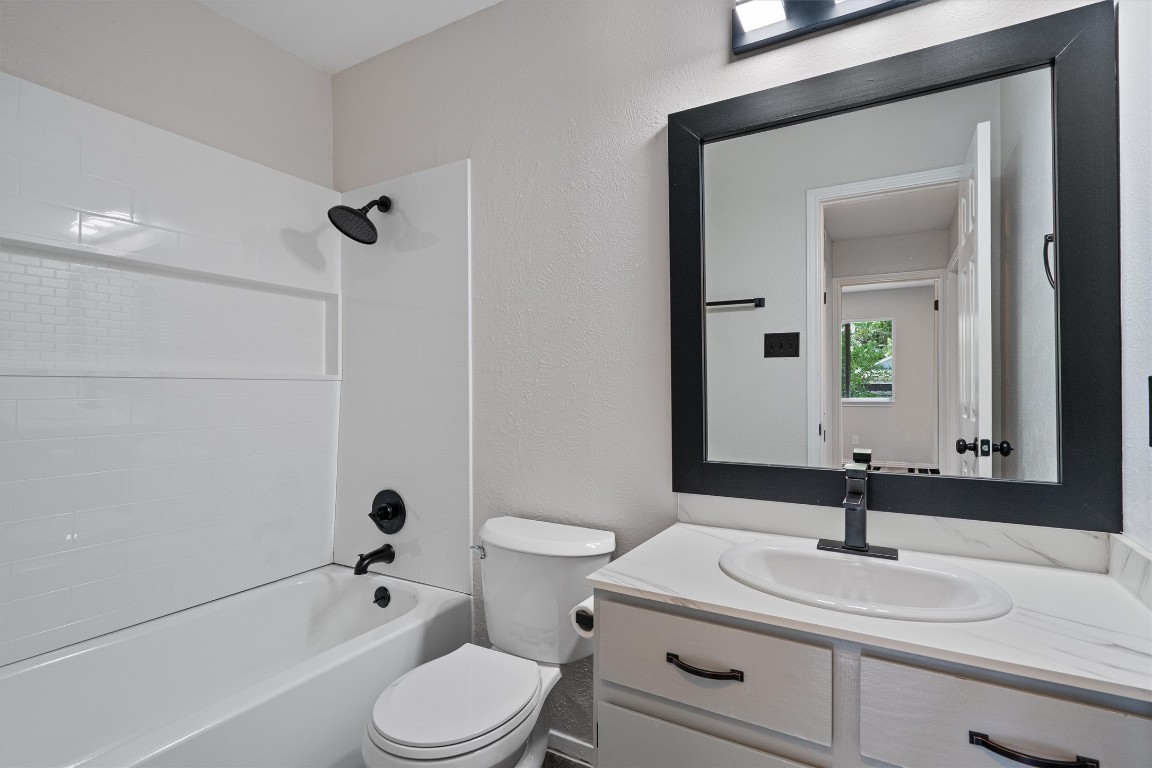 8615 Croydon Loop Austin, TX 78748 - Photo 19 of 28 a bathroom with a sink a toilet and shower