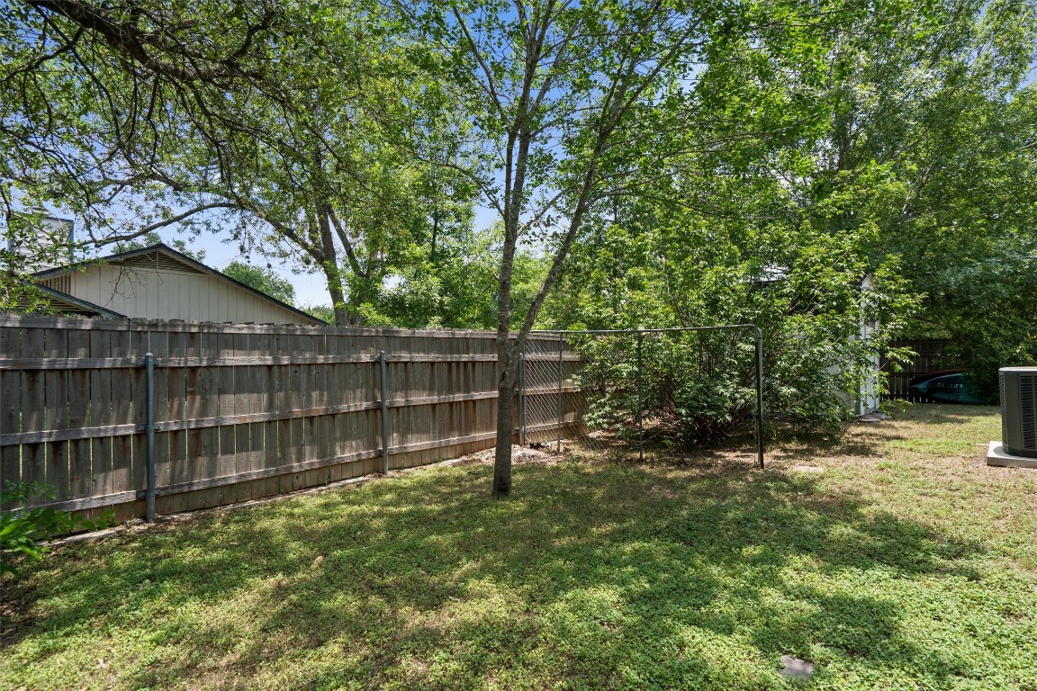 8615 Croydon Loop Austin, TX 78748 - Photo 23 of 28 a view of backyard with wooden fence and large trees