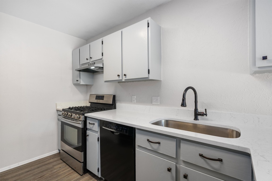8615 Croydon Loop Austin, TX 78748 - Photo 9 of 28 a kitchen with stainless steel appliances granite countertop a sink stove and cabinets
