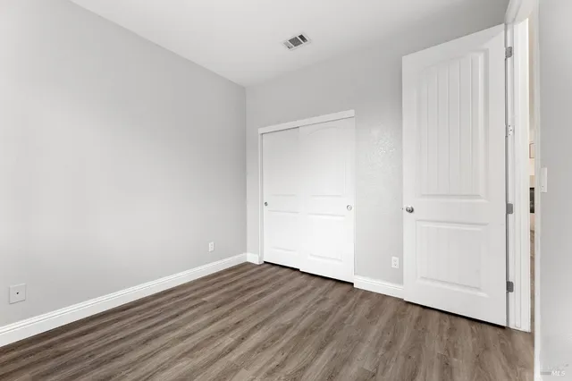 a view of room with wooden floor