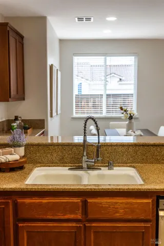 a kitchen with a granite countertop sink and window