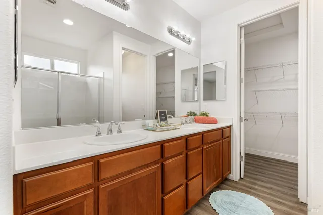 a bathroom with a double vanity sink mirror and double