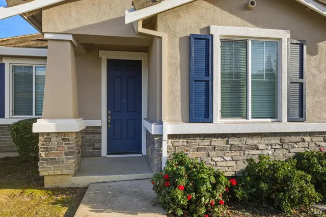 a front view of a house with a plants