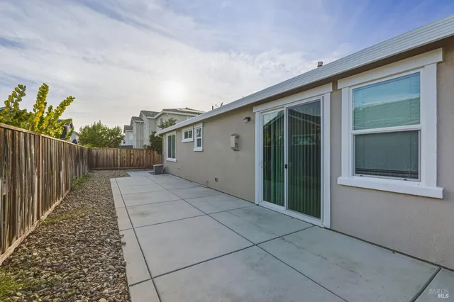 a view of backyard with small cabin and wooden fencing