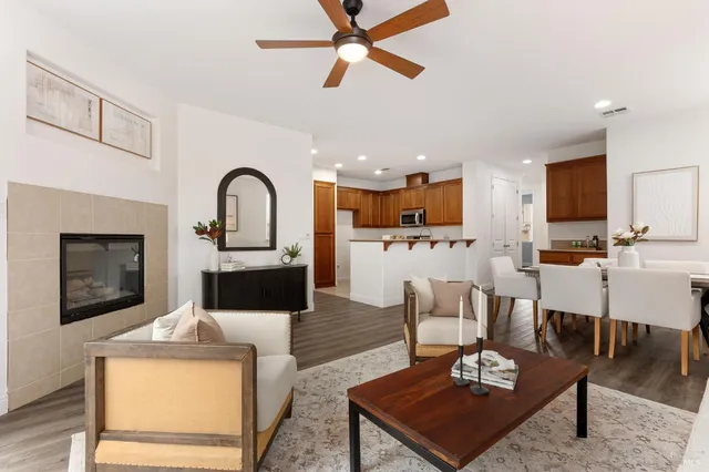 a living room with furniture and kitchen view