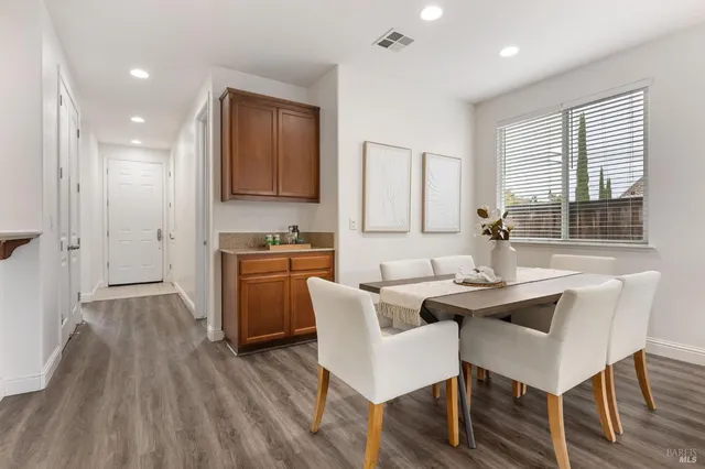 a kitchen with granite countertop a stove a sink dishwasher and a refrigerator with wooden floor