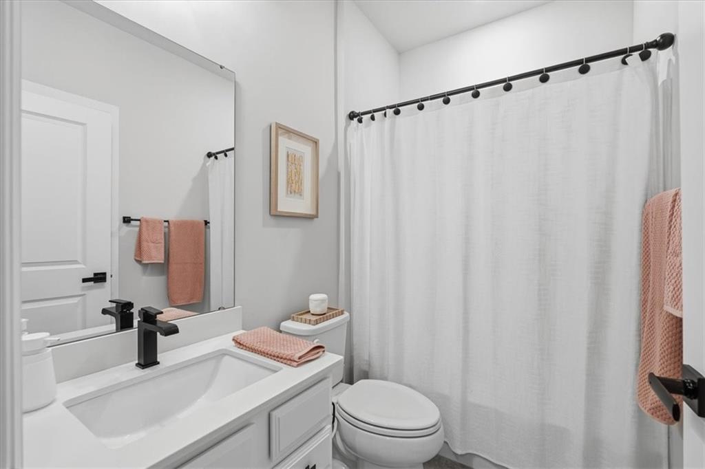 333 Crest Lane Mars, PA 16046 - Photo 24 of 32 a bathroom with a sink a toilet a mirror and shower curtain