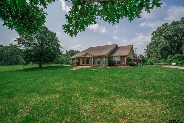 a front view of house with yard and green space