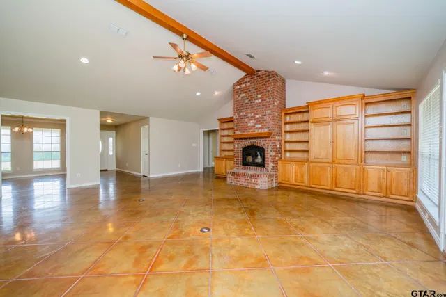 a view of empty room with a fireplace and entryway
