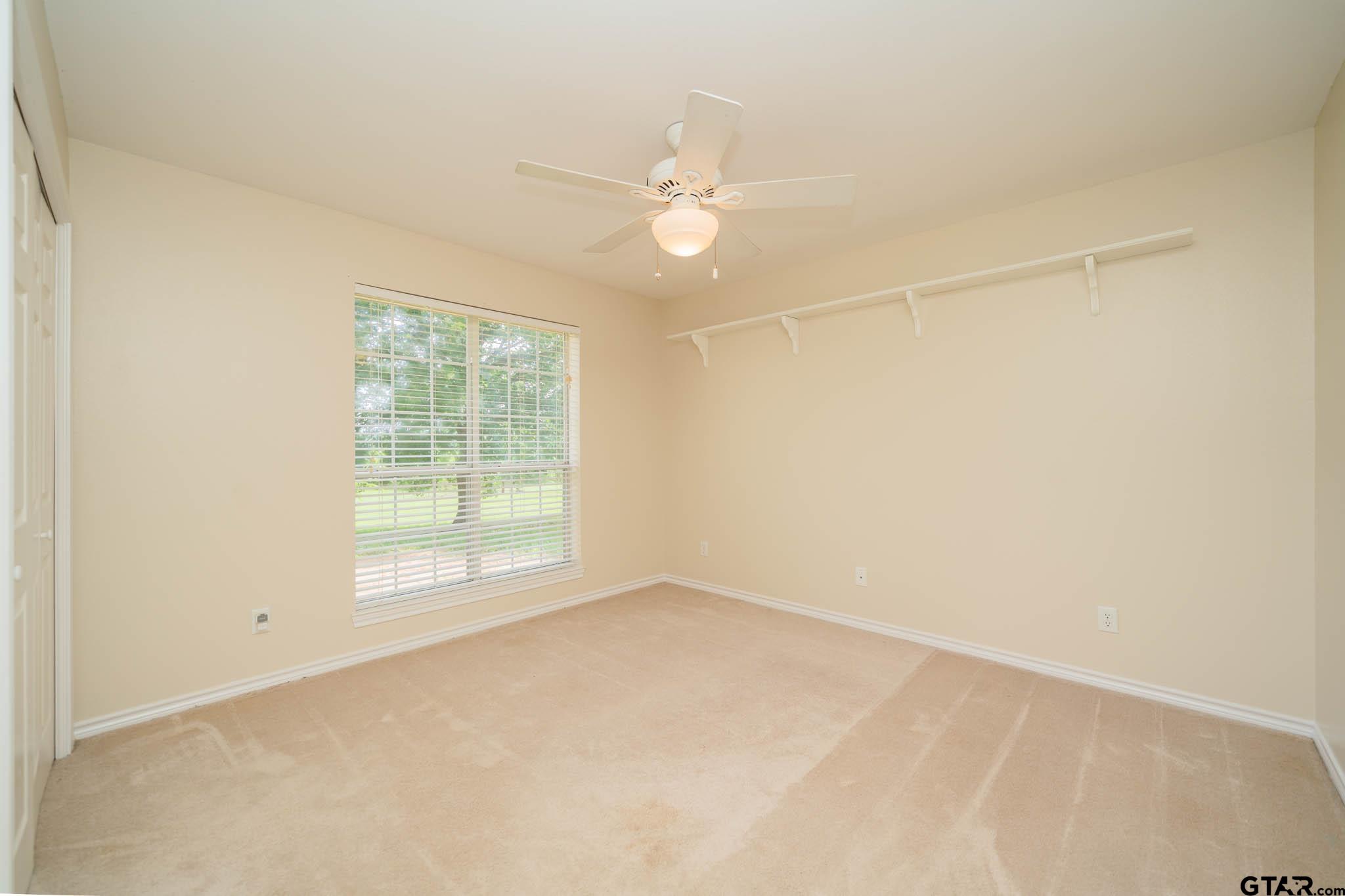 3460 Hawk Road Diana, TX 75640 - Photo 20 of 40 an empty room with a window and a fan