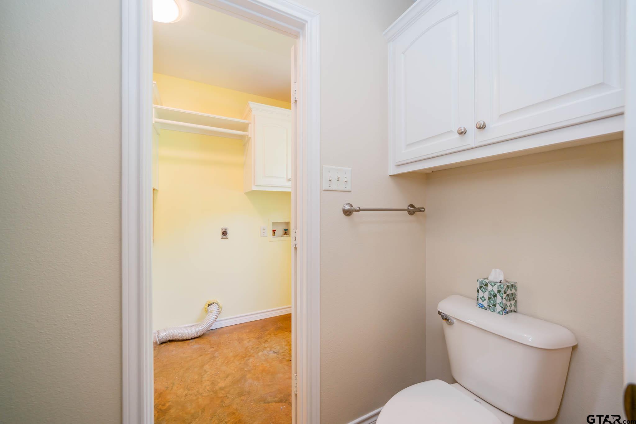 3460 Hawk Road Diana, TX 75640 - Photo 26 of 40 a white toilet sitting next to a bathroom sink