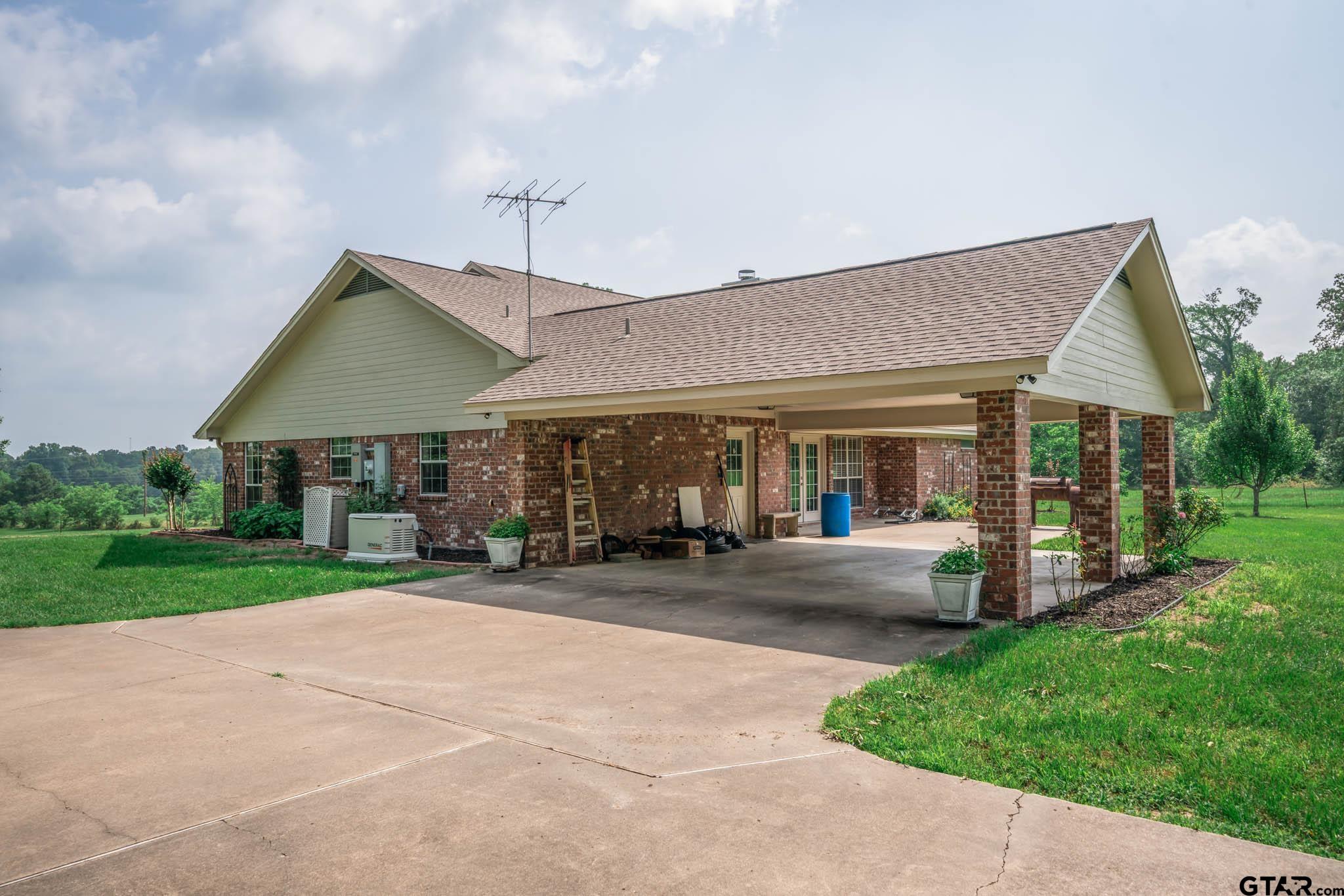 3460 Hawk Road Diana, TX 75640 - Photo 3 of 40 a front view of a house with a garden and patio