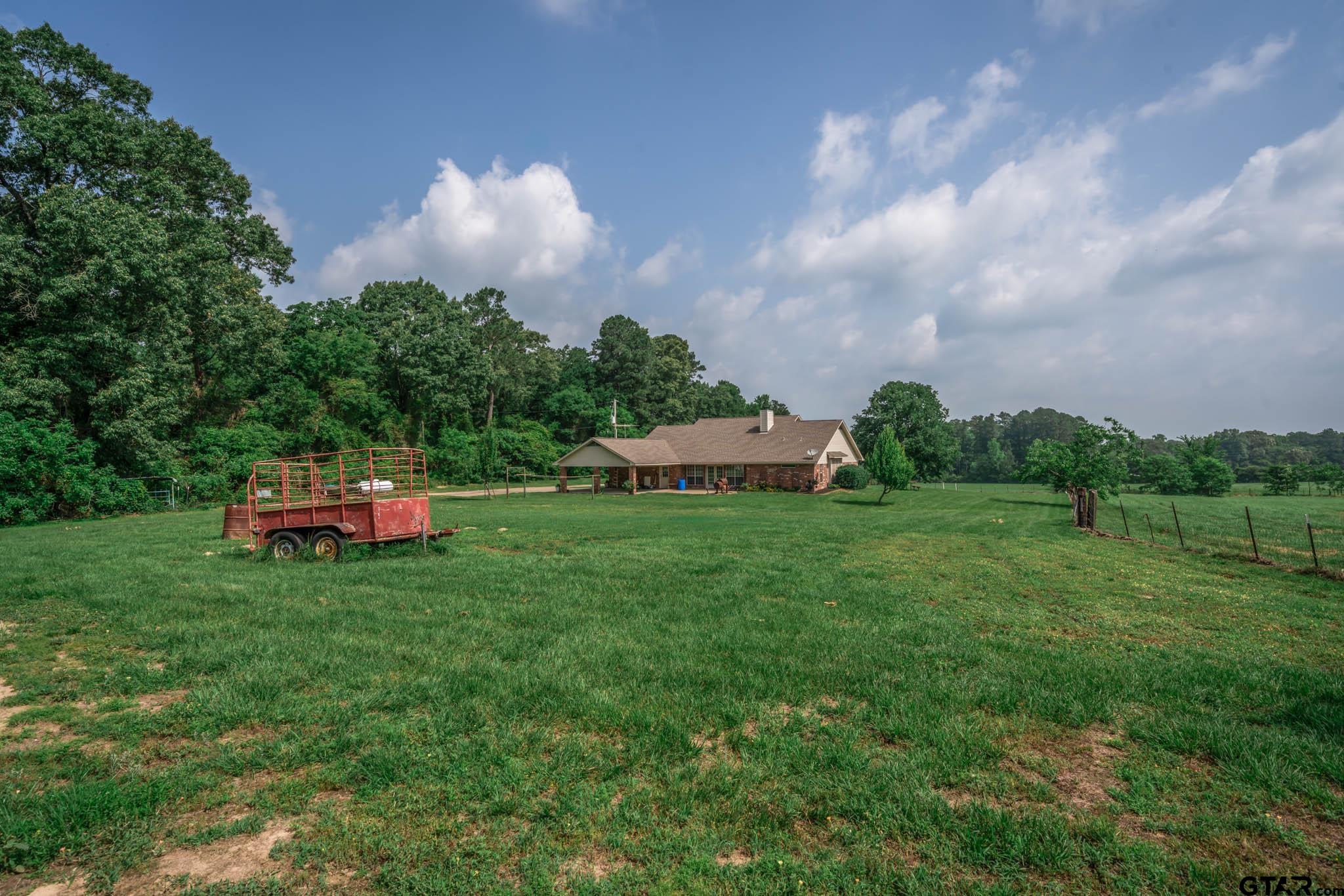 3460 Hawk Road Diana, TX 75640 - Photo 33 of 40 a backyard of a house with table and chairs
