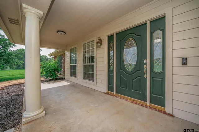 a view of a door with a door and wooden bench