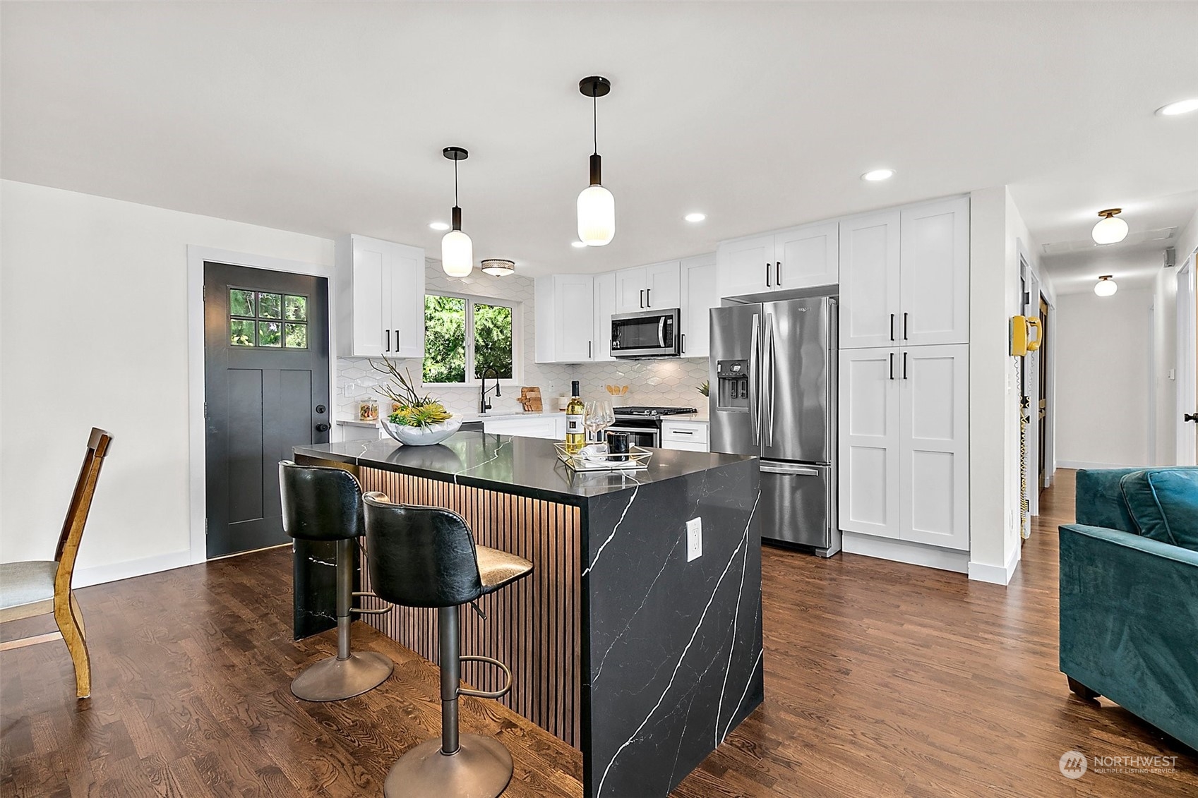 15846 Southeast 132nd Place Renton, WA 98059 - Photo 18 of 37 a kitchen with stainless steel appliances granite countertop a refrigerator a stove a sink dishwasher and a dining table with wooden floor