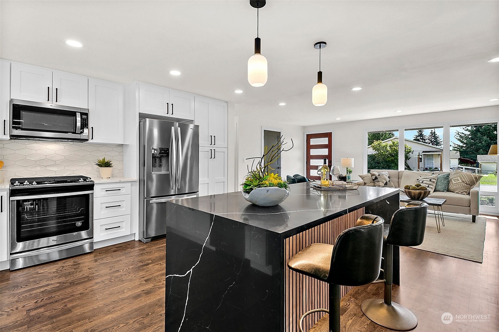 15846 Southeast 132nd Place Renton, WA 98059 - Photo 20 of 37 a kitchen with stainless steel appliances granite countertop a stove a refrigerator a kitchen island a stove and a sink with wooden floor