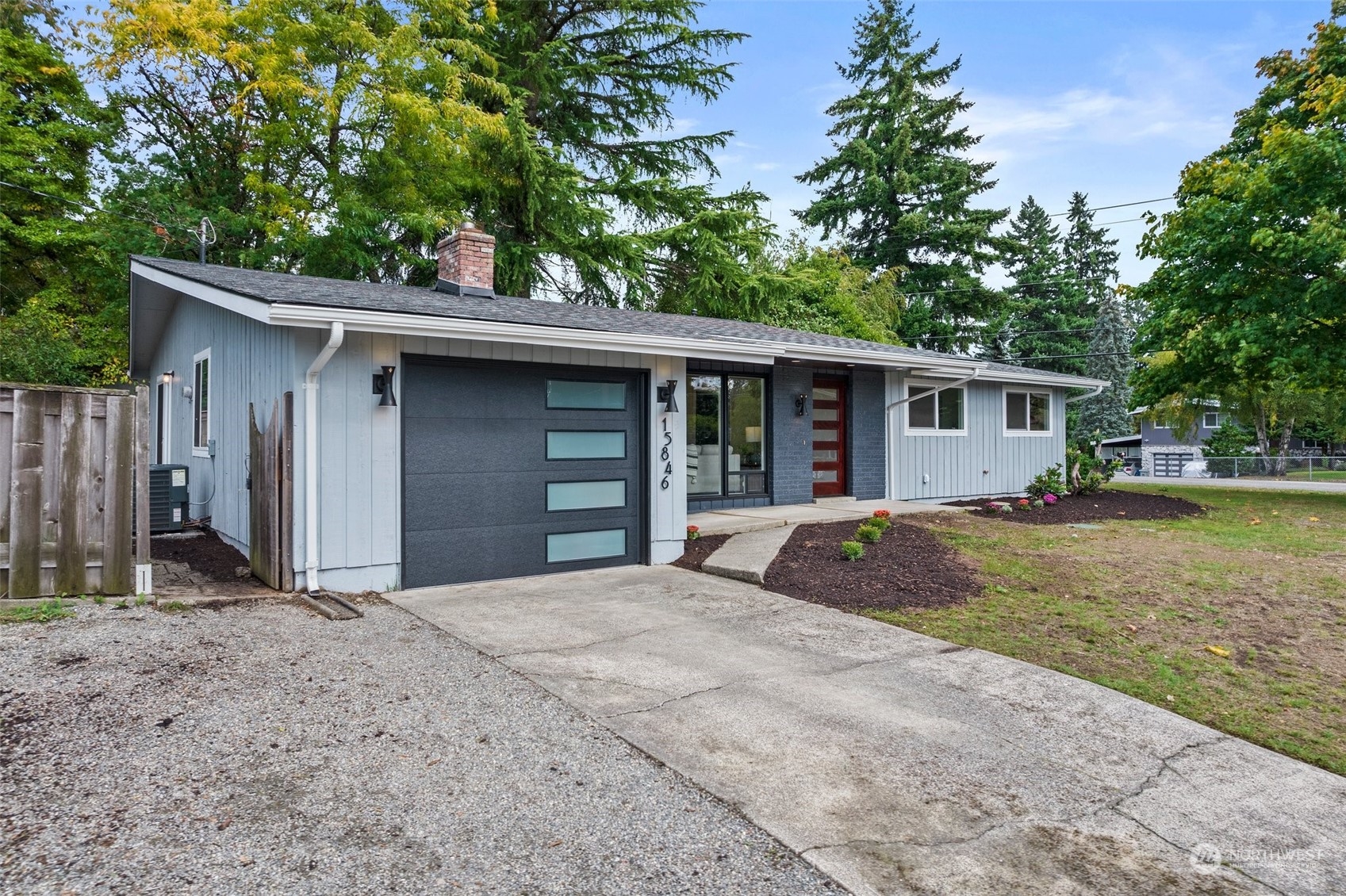 15846 Southeast 132nd Place Renton, WA 98059 - Photo 3 of 37 a front view of a house with a yard garage and outdoor seating