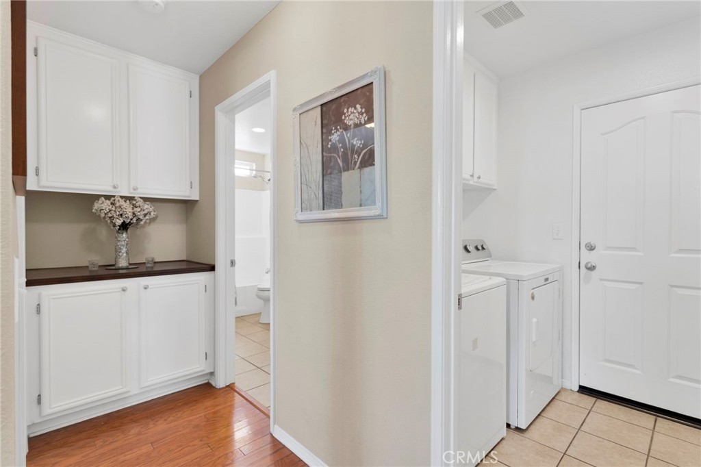 13798 Misty Path Victorville, CA 92392 - Photo 17 of 55 a bathroom with a granite countertop sink and a refrigerator