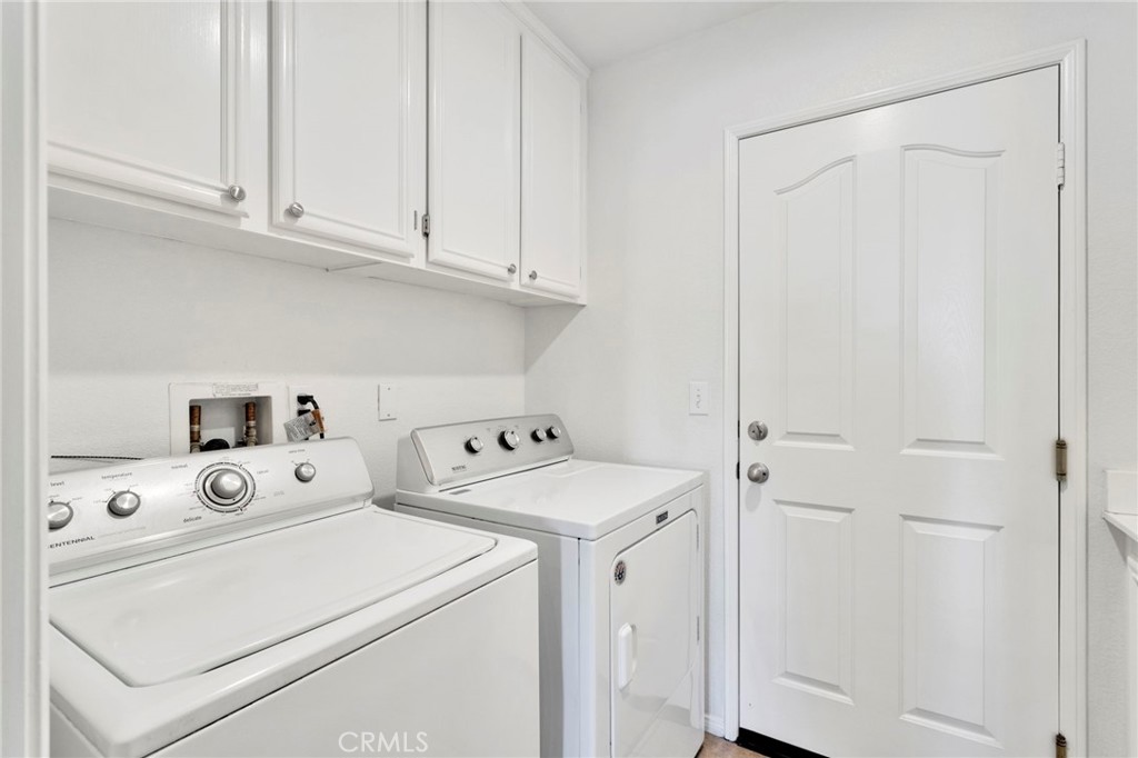 13798 Misty Path Victorville, CA 92392 - Photo 18 of 55 a view of washer and dryer with white cabinet