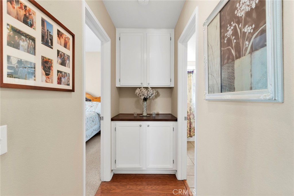 13798 Misty Path Victorville, CA 92392 - Photo 19 of 55 a view of a kitchen with cabinets and wooden floor