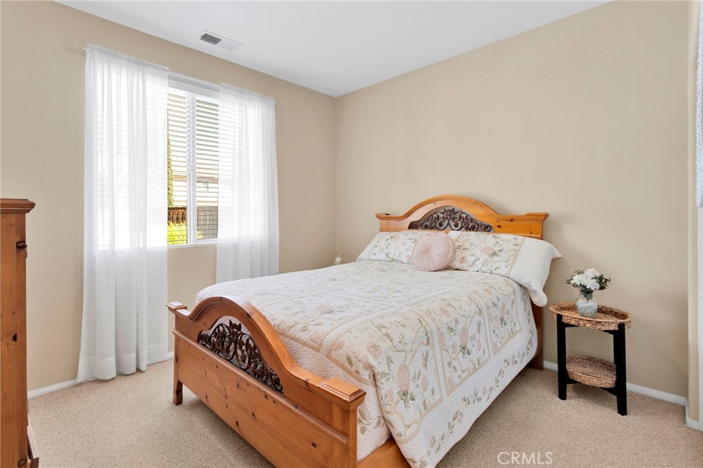 13798 Misty Path Victorville, CA 92392 - Photo 20 of 55 a bedroom with a bed and window