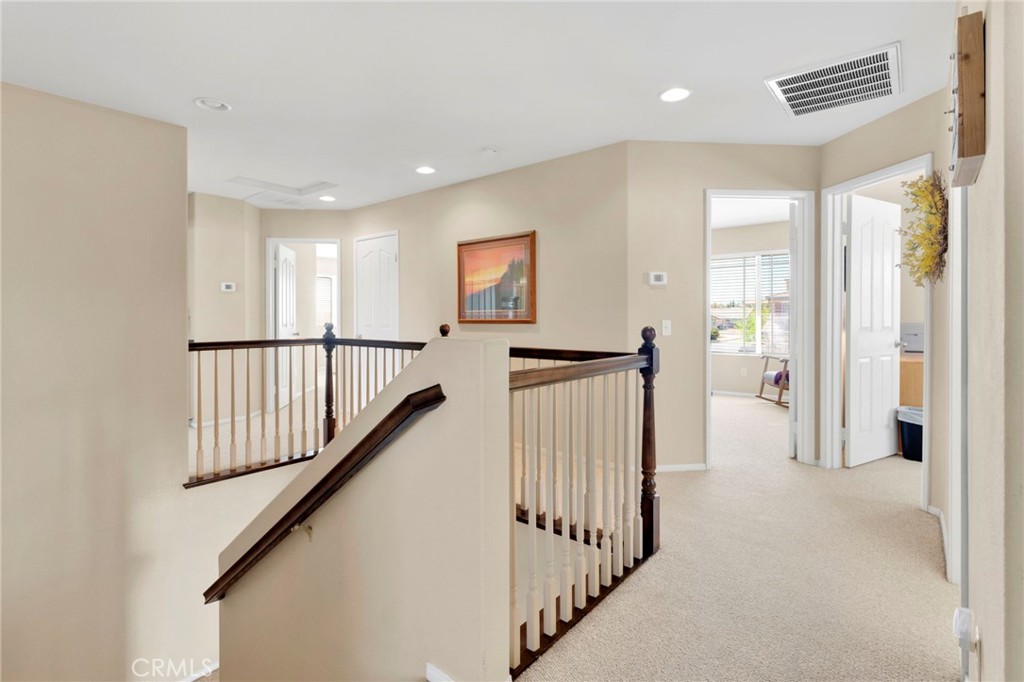 13798 Misty Path Victorville, CA 92392 - Photo 29 of 55 a view of a hallway with wooden floor and stairs