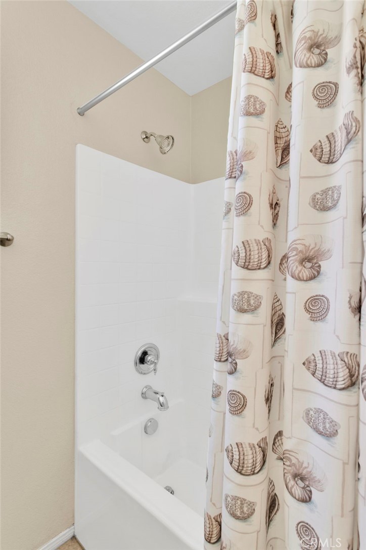 13798 Misty Path Victorville, CA 92392 - Photo 31 of 55 a bathroom with a bathtub and shower curtain