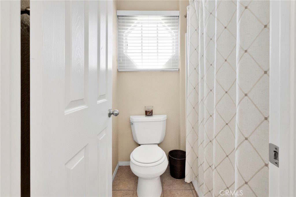 13798 Misty Path Victorville, CA 92392 - Photo 37 of 55 a bathroom with a toilet a sink and a window