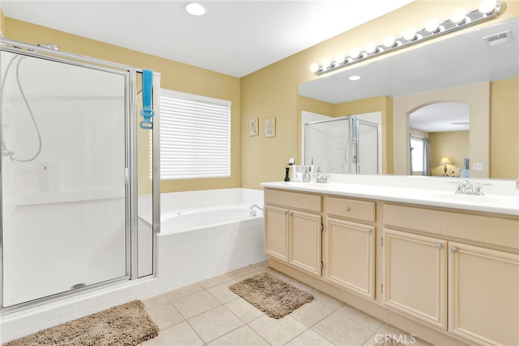 13798 Misty Path Victorville, CA 92392 - Photo 44 of 55 a spacious bathroom with a double vanity sink a mirror and a bathtub