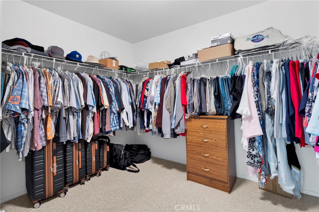 13798 Misty Path Victorville, CA 92392 - Photo 46 of 55 a view of walk in closet with clothes and shoes