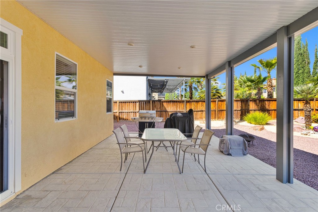 13798 Misty Path Victorville, CA 92392 - Photo 48 of 55 a dining room with furniture and a floor to ceiling window