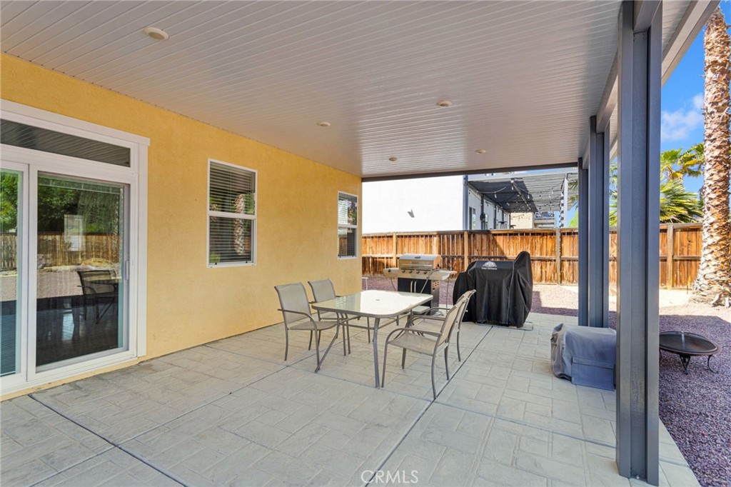 13798 Misty Path Victorville, CA 92392 - Photo 49 of 55 a dining room with furniture and a floor to ceiling window