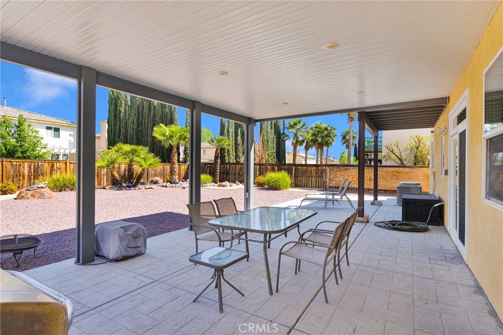 13798 Misty Path Victorville, CA 92392 - Photo 50 of 55 a view of a dining room with furniture large windows and wooden floor