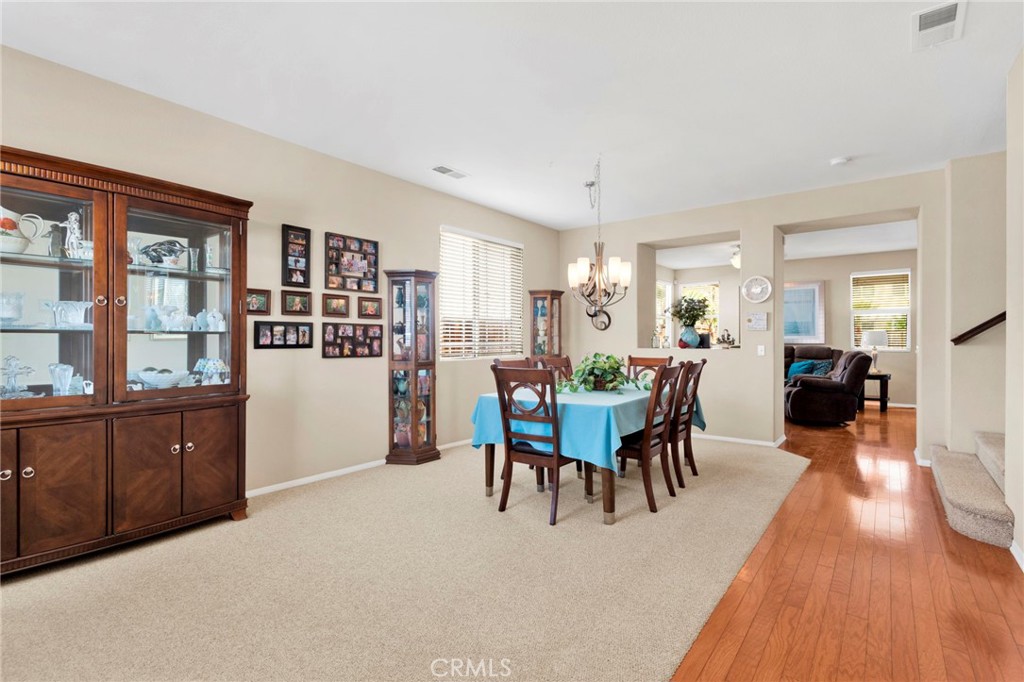 13798 Misty Path Victorville, CA 92392 - Photo 6 of 55 a view of a dining room with furniture and wooden floor