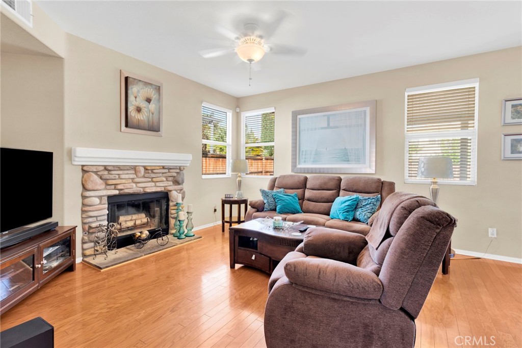 13798 Misty Path Victorville, CA 92392 - Photo 9 of 55 a living room with furniture a fireplace and a flat screen tv
