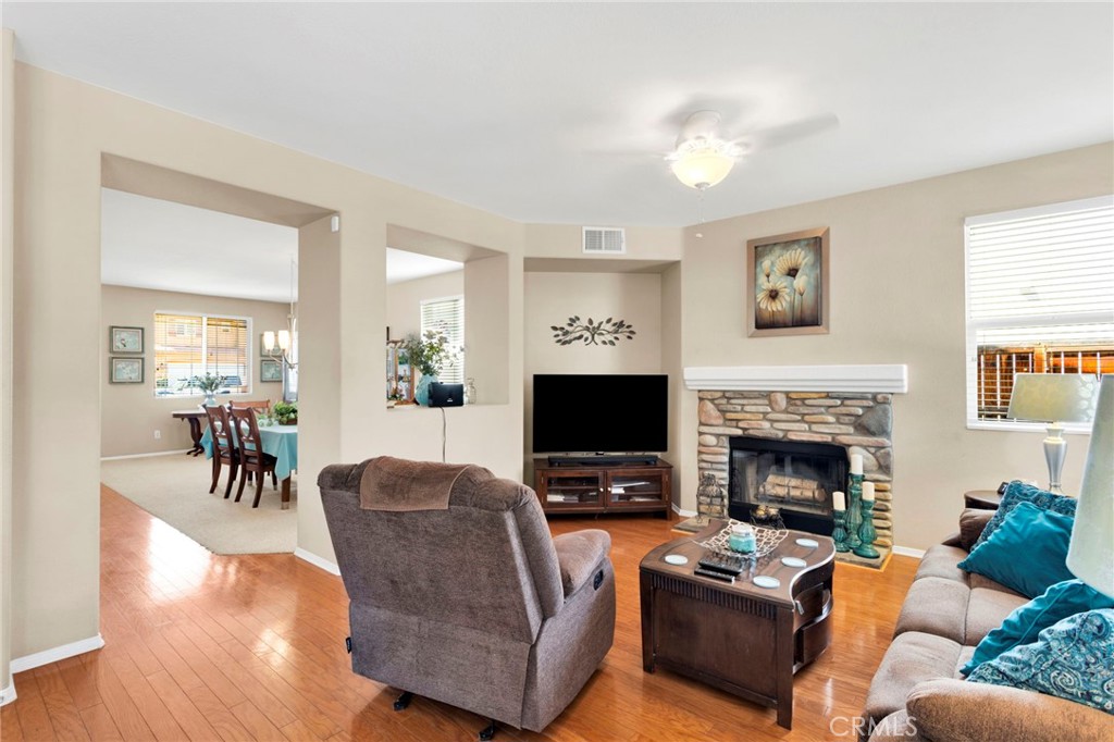 13798 Misty Path Victorville, CA 92392 - Photo 10 of 55 a living room with furniture a fireplace and a flat screen tv