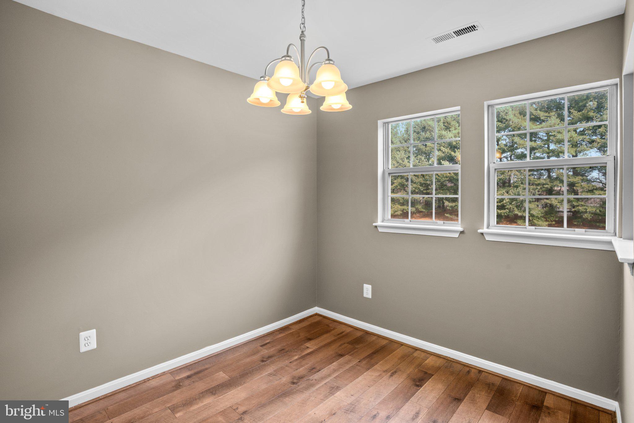 8335 Montgomery Run Road, Unit K Ellicott City, MD 21043 - Photo 12 of 42 a view of wooden floor and chandelier in a room
