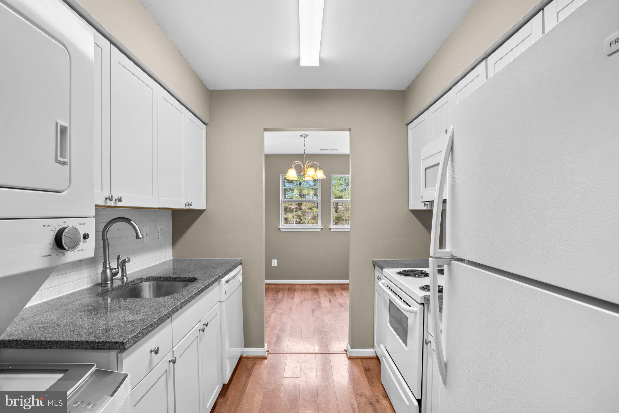 8335 Montgomery Run Road, Unit K Ellicott City, MD 21043 - Photo 14 of 42 a kitchen with a sink a window and appliances