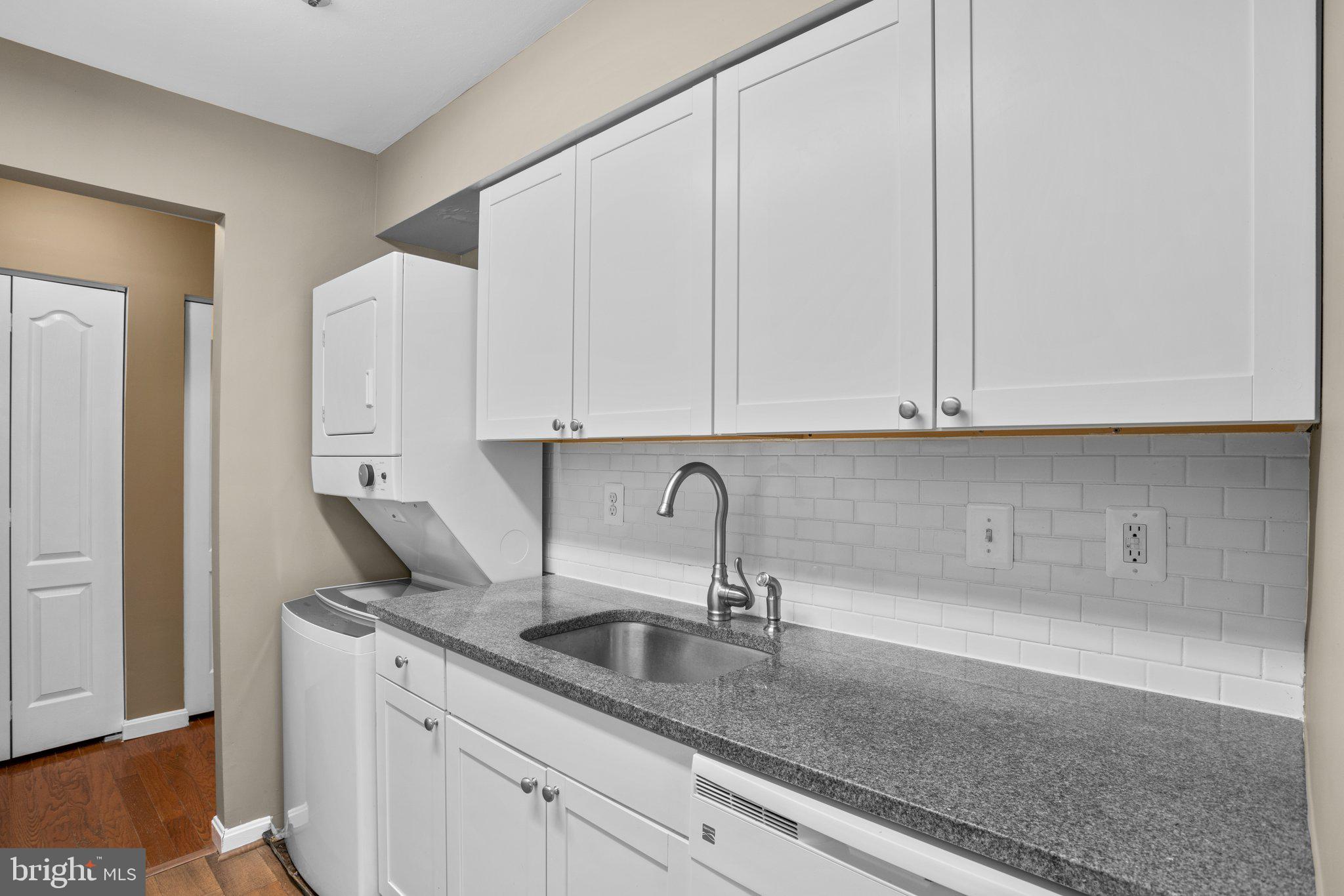 8335 Montgomery Run Road, Unit K Ellicott City, MD 21043 - Photo 17 of 42 a kitchen with stainless steel appliances granite countertop white cabinets and a sink
