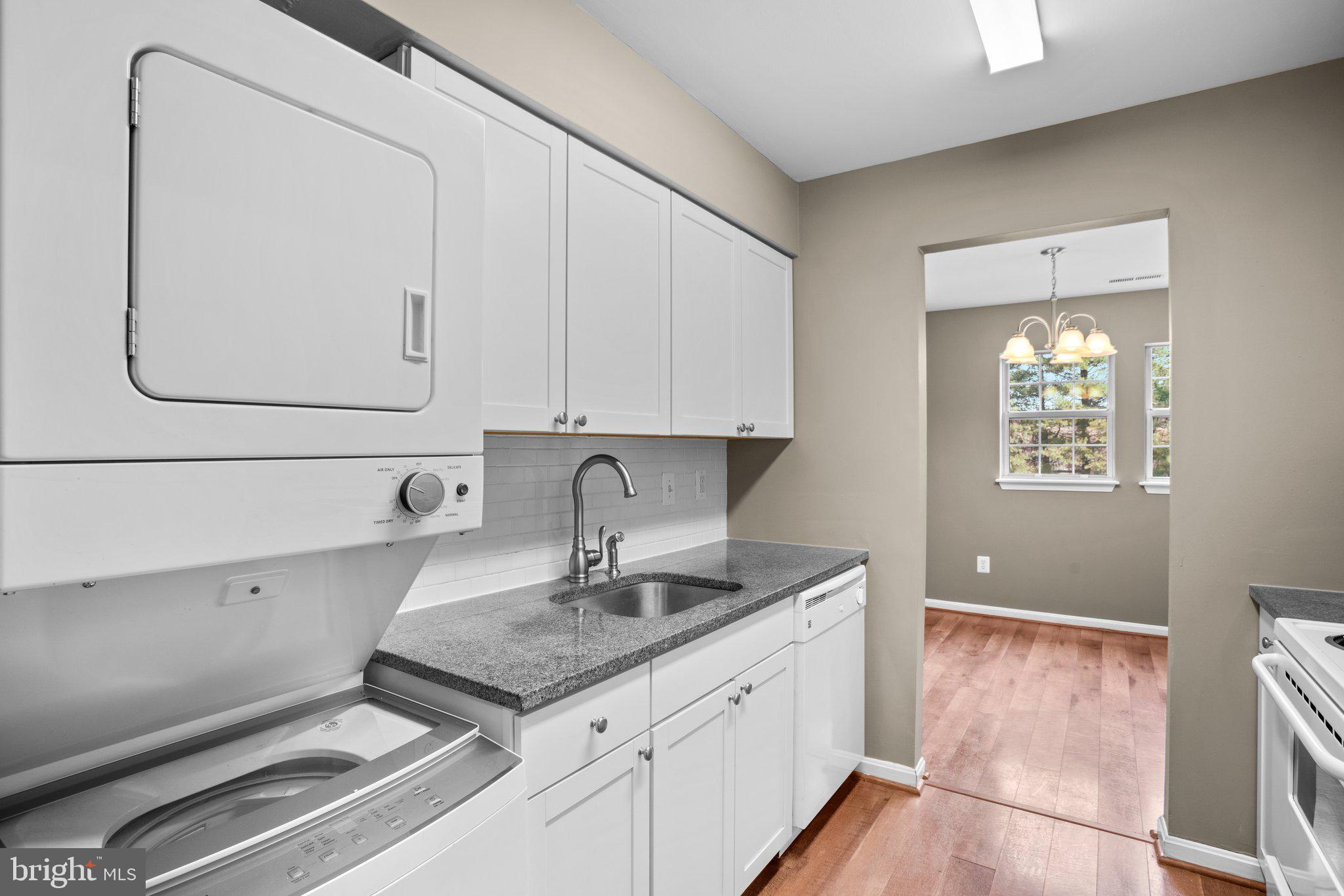 8335 Montgomery Run Road, Unit K Ellicott City, MD 21043 - Photo 20 of 42 a kitchen with stainless steel appliances granite countertop a sink and a white cabinets